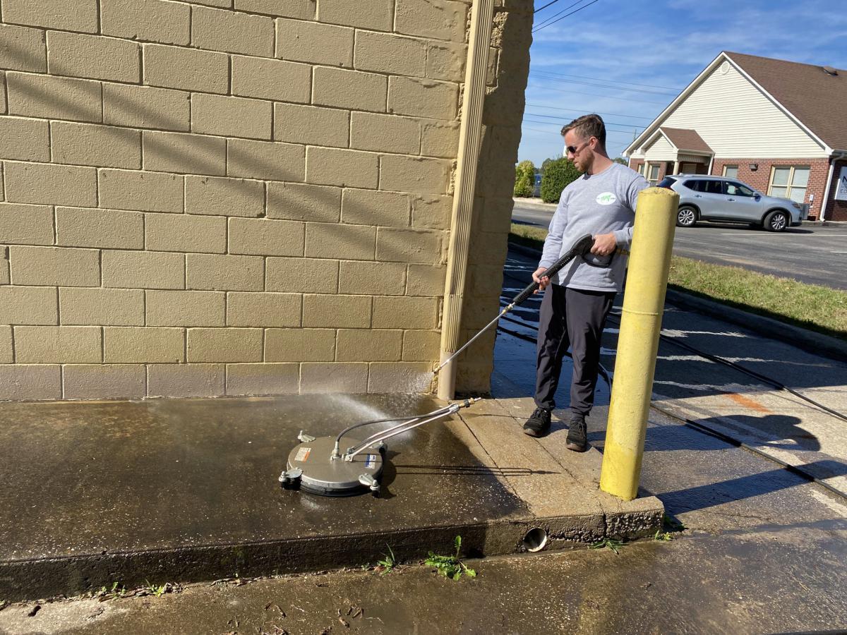 Pressure washed commercial storefront walkway