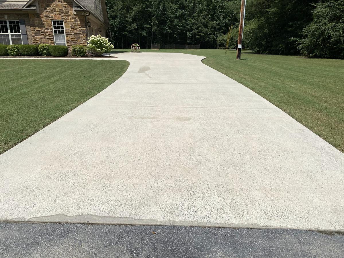 Concrete driveway being pressure washed